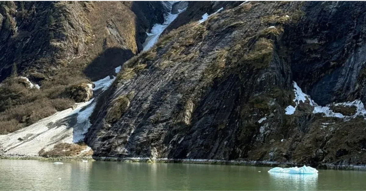 Snow capped mountains and glacier fjord with floating ice viewed from an Alaska cruise ship